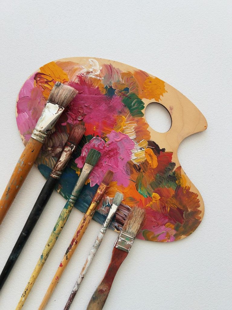 Artist palette with brushes and vibrant colours.